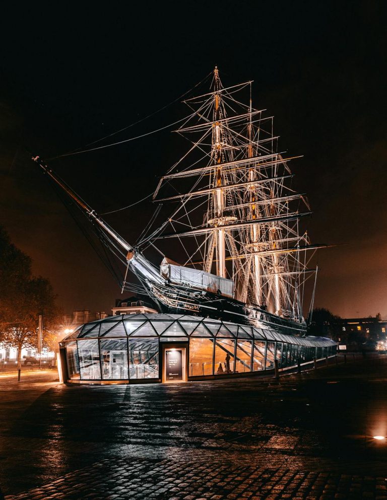 Night view of the iconic Cutty Sark ship in London, beautifully illuminated.