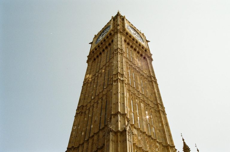 View of Big Ben in London from a low angle on a clear day, showcasing its architectural beauty.