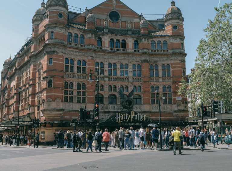 Historic Palace Theatre in London with crowds gathered for Harry Potter show.