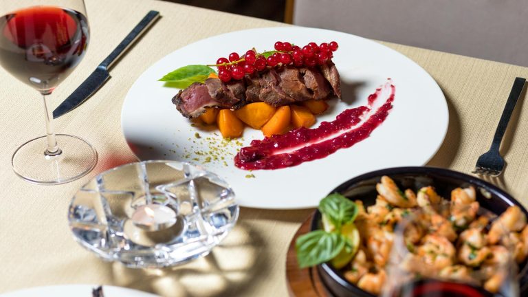 Delicious gourmet steak dinner with wine, served elegantly for fine dining.