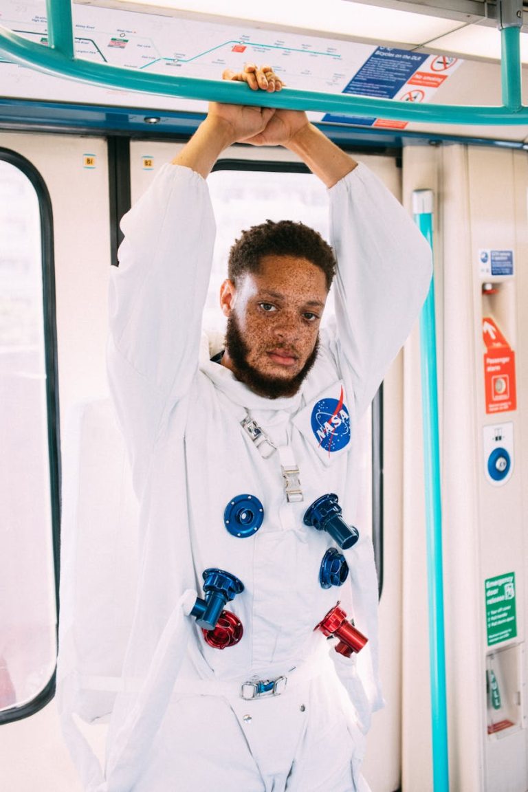 Man in astronaut costume riding London subway for a unique and quirky portrait.