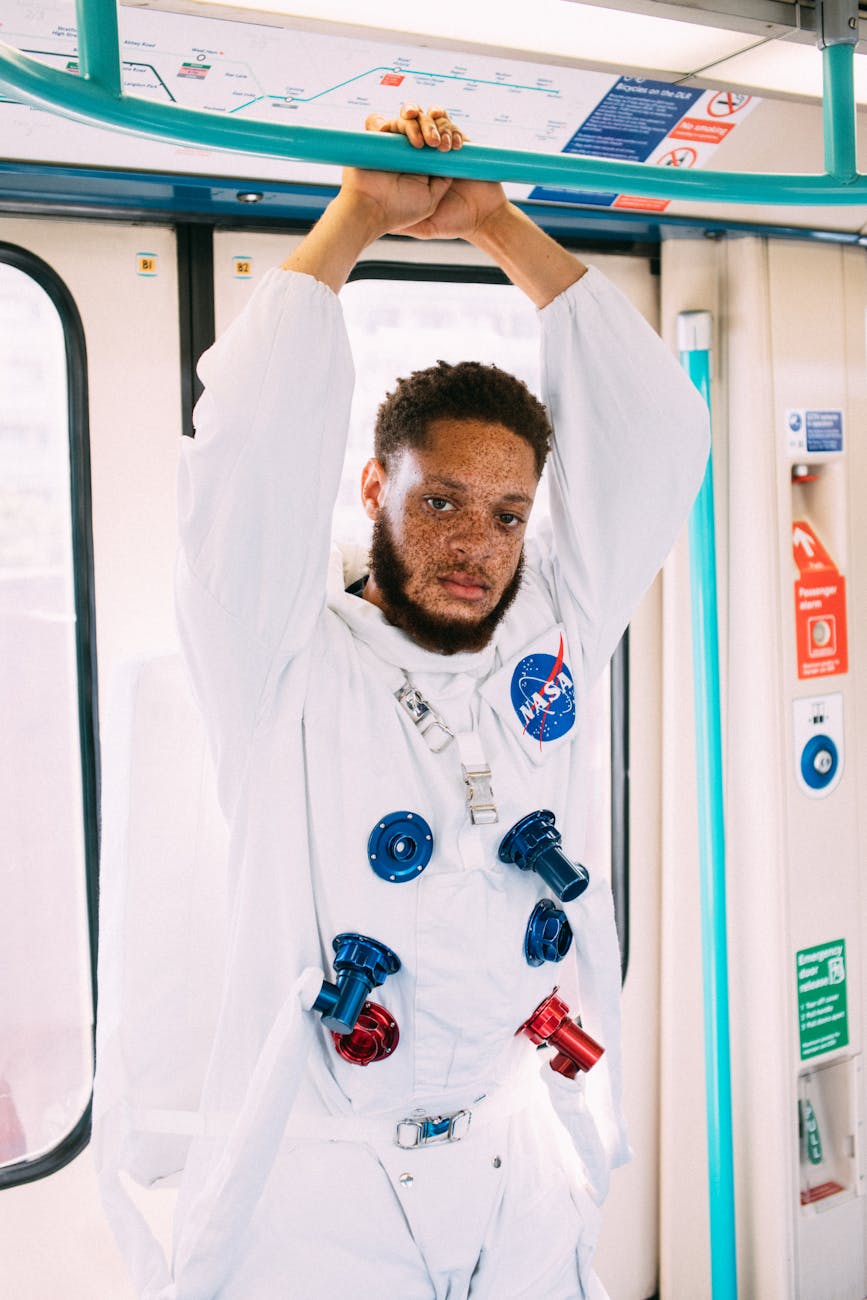 Man in astronaut costume riding London subway for a unique and quirky portrait.