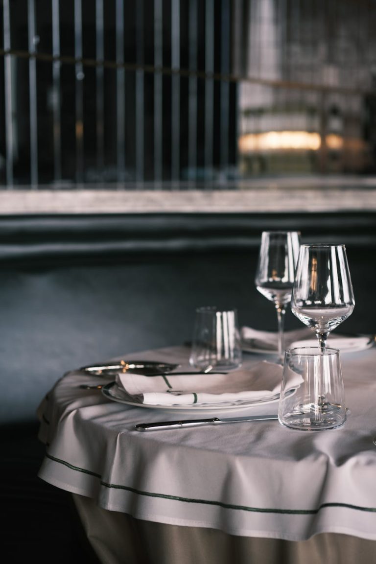 Elegant dining table setup with wine glasses and cutlery, perfect for a luxurious dining experience.