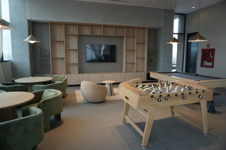 Spacious lounge in Guadalajara featuring foosball and pool tables.