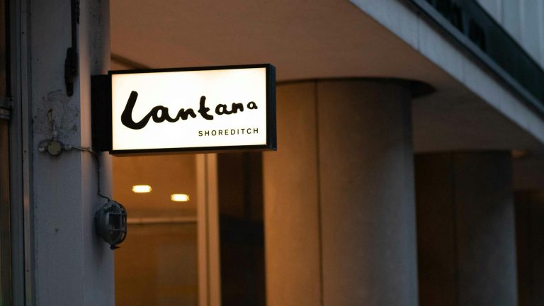 A glowing café sign for Lantana captures the urban charm of Shoreditch during the evening.