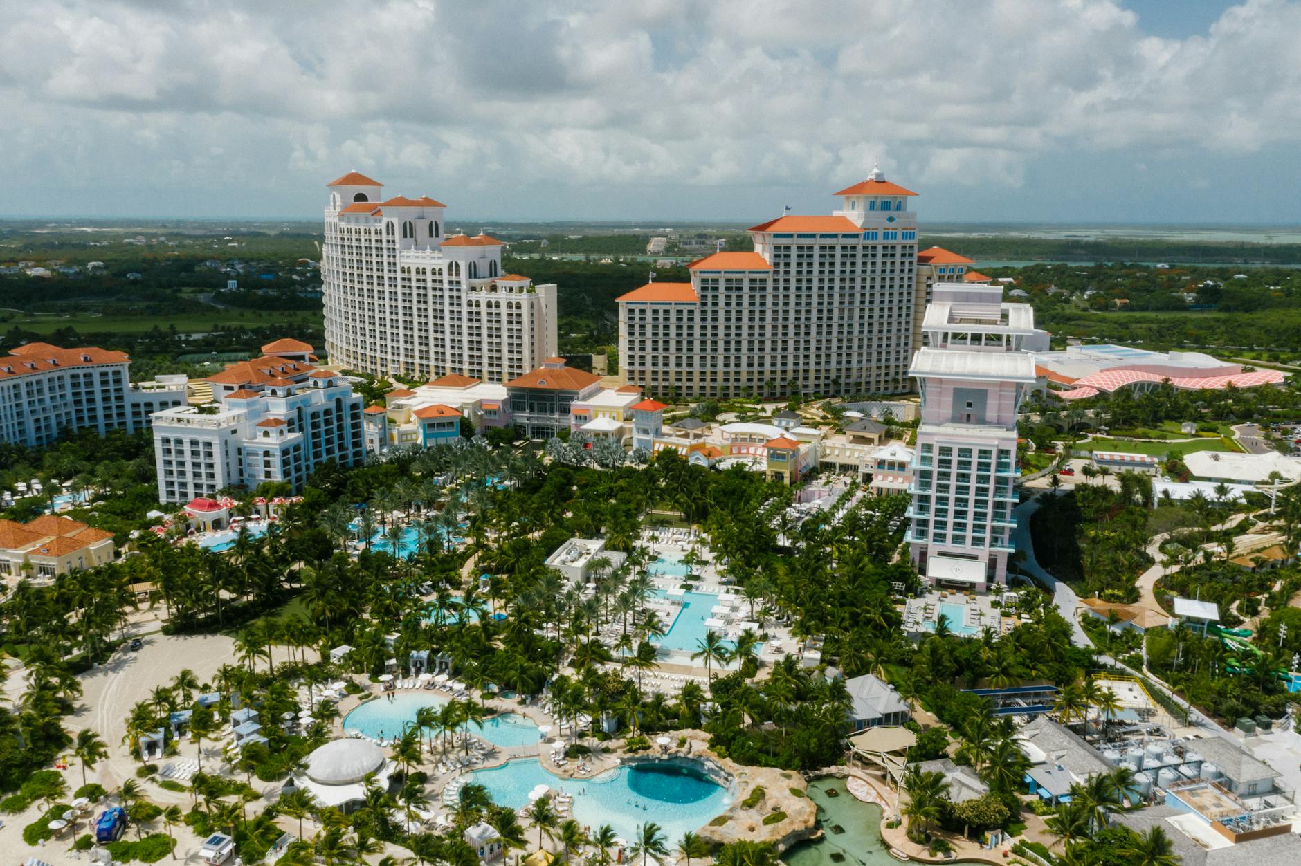 Luxury resort landscape with palm trees and pools in Baha Mar, Bahamas.