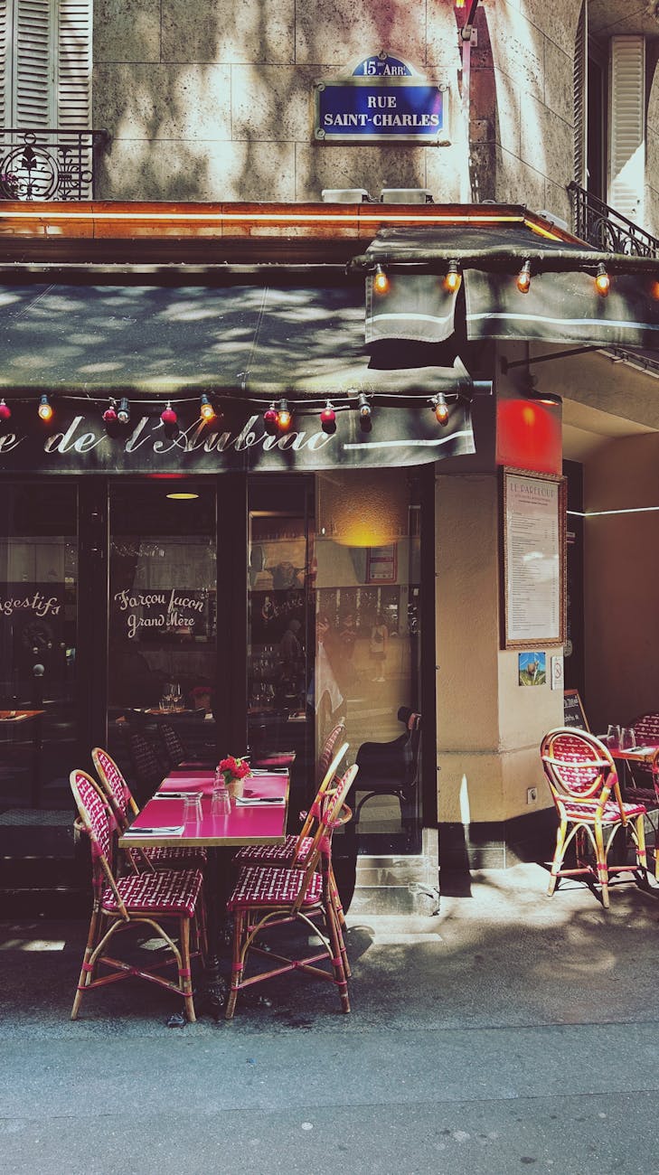 Cozy outdoor cafe seating in Paris with vibrant decor and Parisian charm.