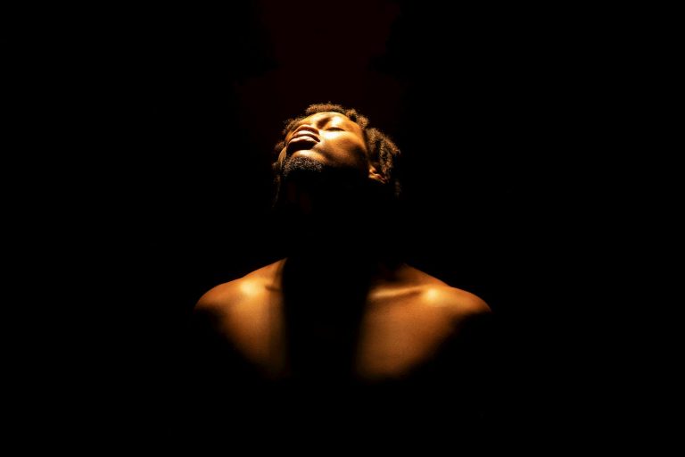 A powerful portrait capturing a man under dramatic lighting, evoking emotion.