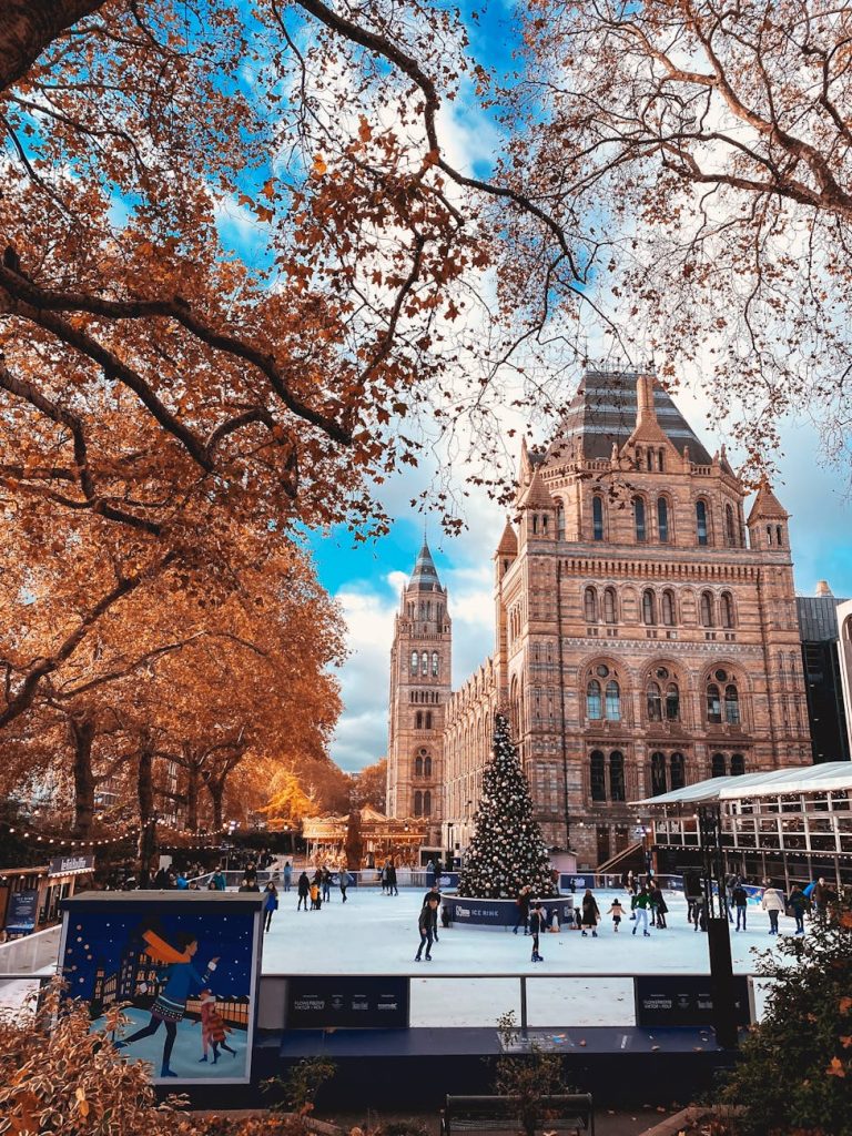 Beautiful winter ice rink at the Natural History Museum in London with a giant Christmas tree.