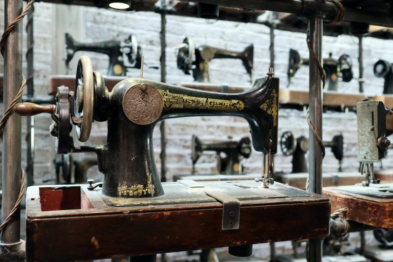 Close-up of a vintage sewing machine on display in a London shop, showcasing its intricate design.