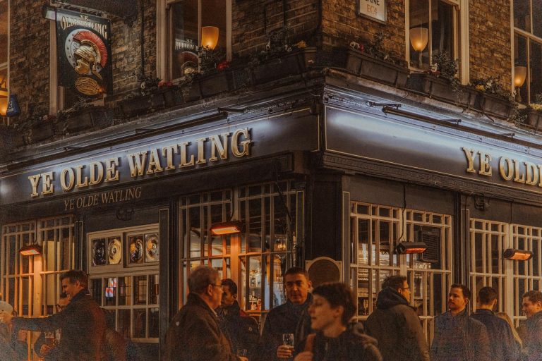 Nighttime scene at Ye Olde Watling Pub in London, capturing city life and local culture.