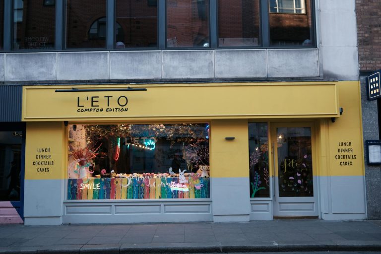 Colorful street view of L'ETO Compton Edition Cafe with artistic decor.