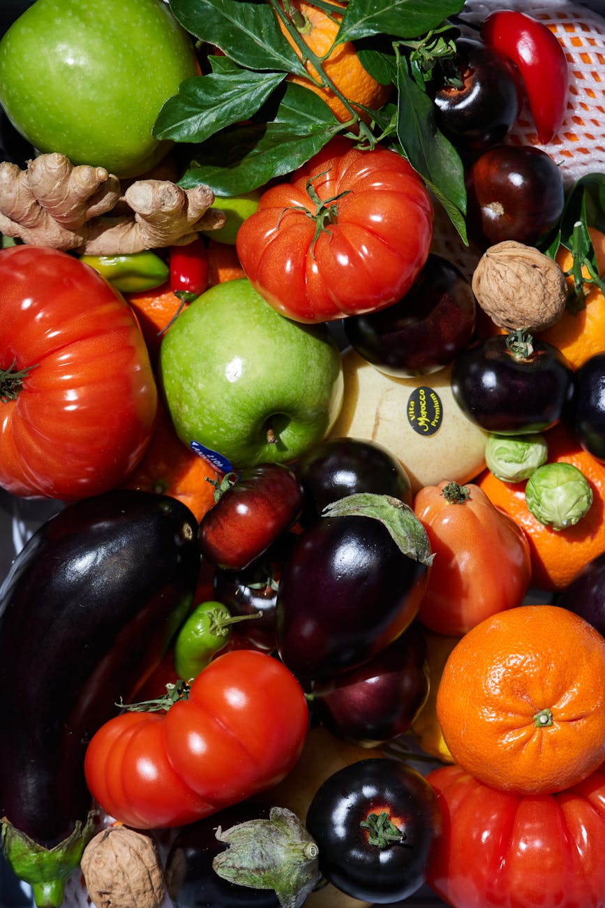 A colorful mix of fresh fruits and vegetables, including tomatoes, peppers, and ginger, photographed in London.