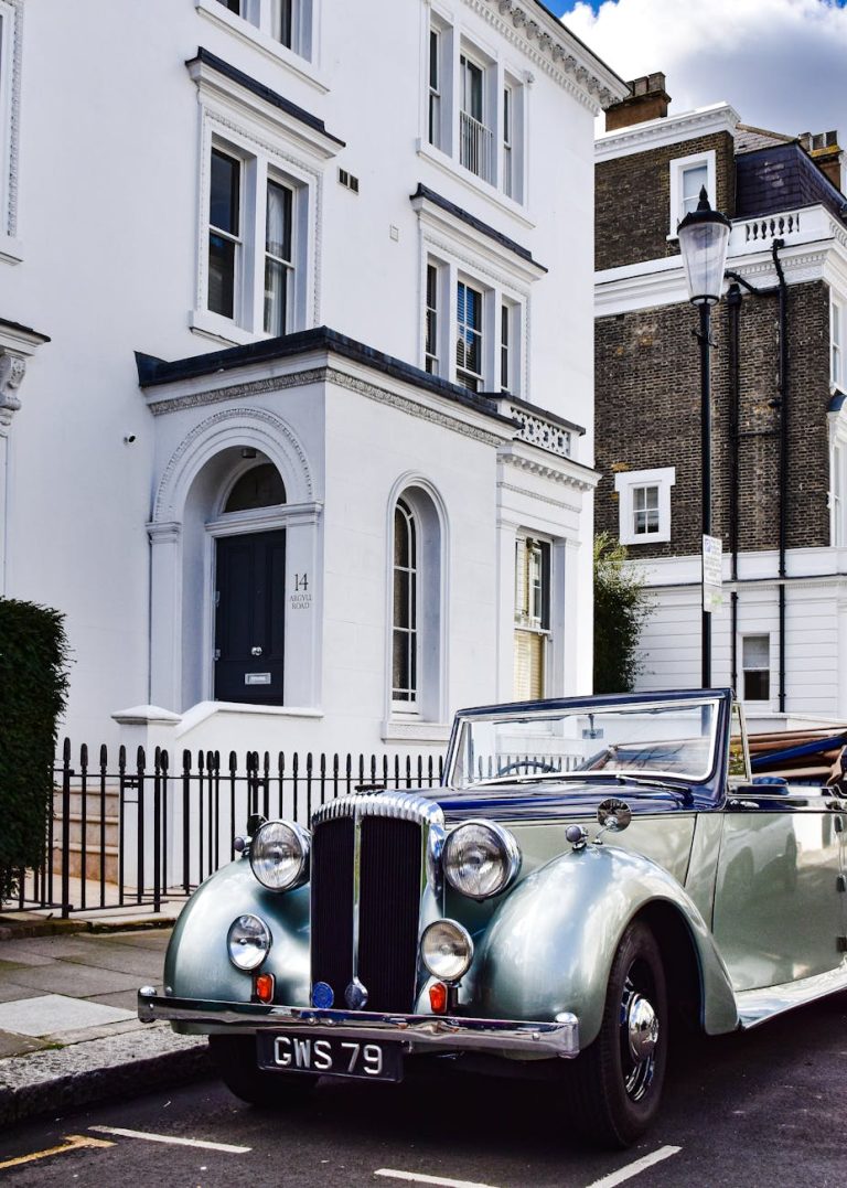 Classic Daimler DB18 parked in a charming London residential area with elegant facades.